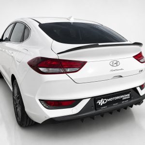 A-477_2jpg - OPSHOLDERS Rear view of a white Hyundai i30 hatchback with a black spoiler in a studio setting