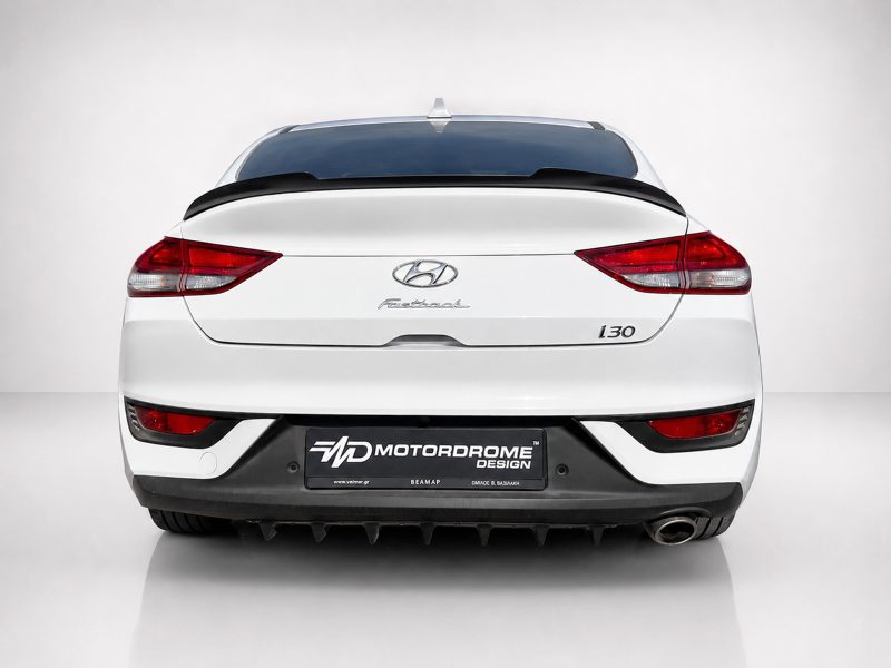 A-477_3jpg - OPSHOLDERS Rear view of a white Hyundai i30 with visible emblem and 'i30' badge, plus a black Motordrome Design plate in a studio setting