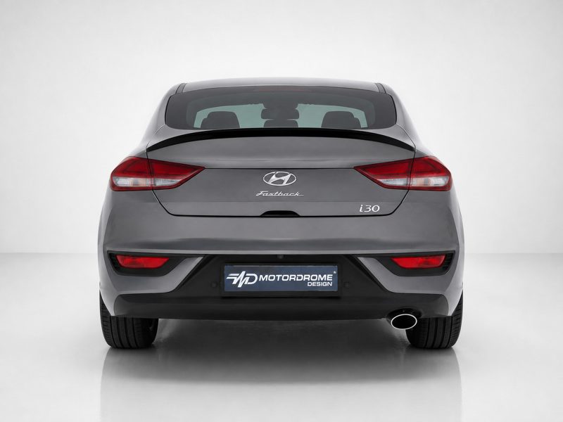 Rear view of a gray Hyundai i30 Fastback, showing taillights and the Motordrome Design plate on the bumper bed.