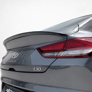 Rear view of a metallic gray Hyundai i30 Fastback, showing the taillight, trunklid, and badge.