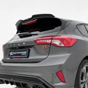 Rear view of a gray Ford Focus hatchback with sporty ST badge, showing large rear spoiler and dual exhausts