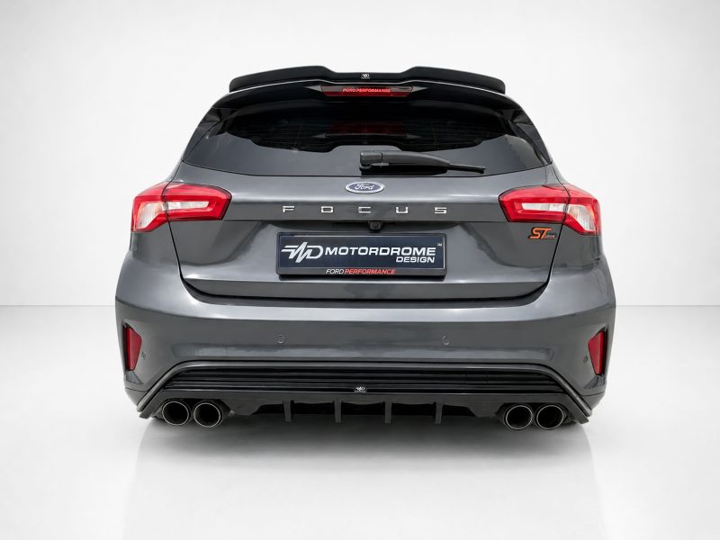 A-479_3jpg - OPSHOLDERS Rear view of a gray Ford Focus ST hatchback with quad exhausts and a Motordrome Design plate, Ford Performance badge visible