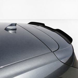 A-479_4jpg - OPSHOLDERS Close-up of a metallic gray car roof showing a small shark-fin antenna and a rear spoiler.