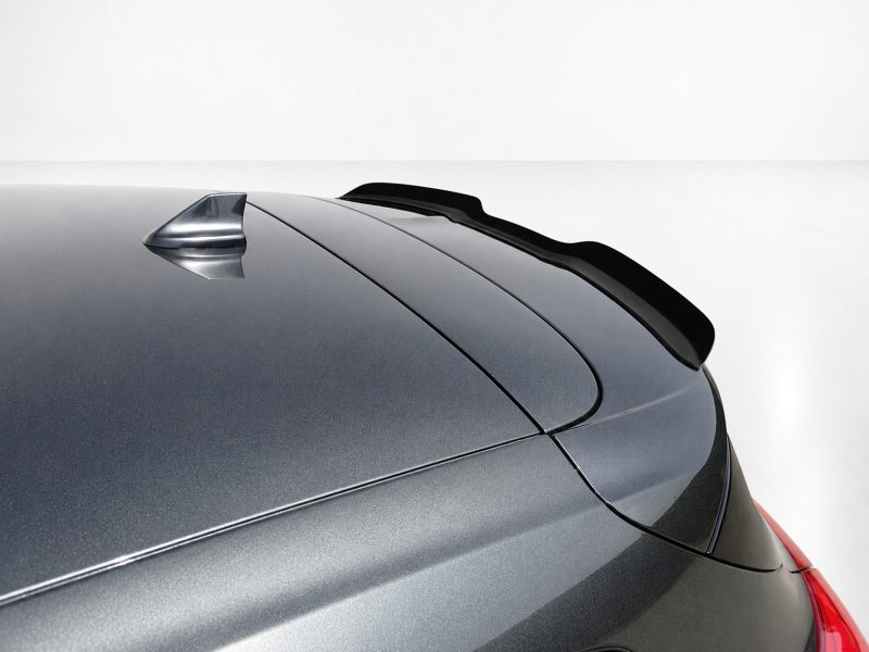 A-479_4jpg - OPSHOLDERS Close-up of a metallic gray car roof showing a small shark-fin antenna and a rear spoiler.