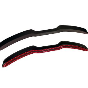 A-479_5jpg - OPSHOLDERS Pair of curved black automotive trim pieces with red braided interior on the underside, laid parallel and facing opposite directions