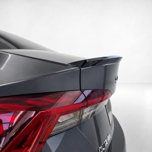 Rear view of a dark gray car showing a spoiler and red taillight assembly in the trunk area.