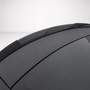 Close-up of a dark gray car roof with multiple panels and a sunroof dome showing smooth, angled lines.