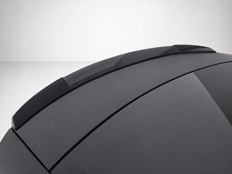 Close-up of a dark gray car roof with multiple panels and a sunroof dome showing smooth, angled lines.