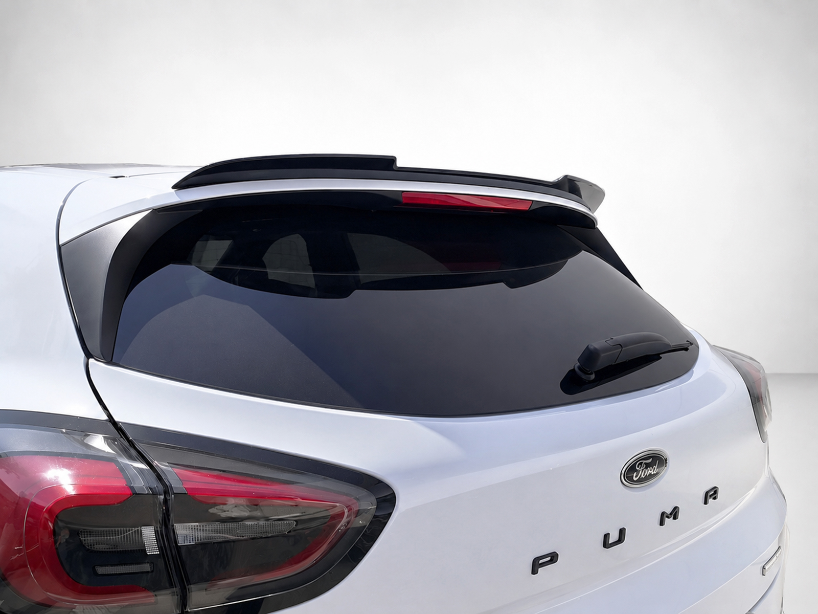 A-481_1jpg - OPSHOLDERS Rear view of a white Ford Puma with a roof spoiler and tinted rear window
