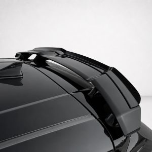 Close-up of a glossy black car rear spoiler mounted on the trunk, against a neutral backdrop.