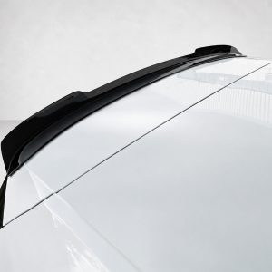 Close-up of a white car roof with a black rear roof spoiler along the edge, reflecting light on a clean surface.