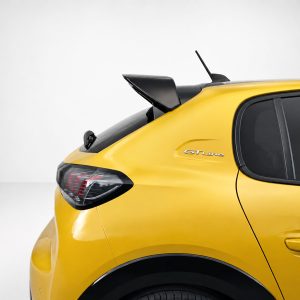 Rear side view of a bright yellow car with a black rear spoiler, GT Line badge, and dark rear window glass against a light background.