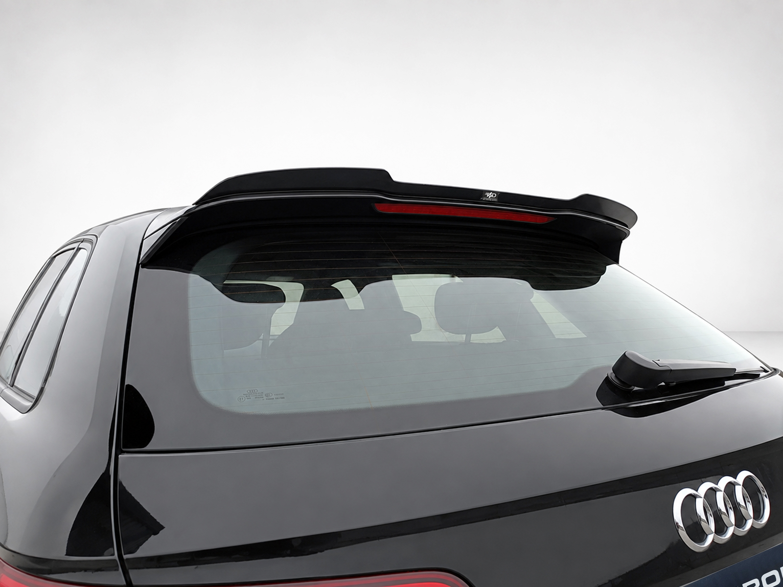 A-487_1jpg - OPSHOLDERS Rear of a black Audi SUV with a raised rooftop spoiler and rear wiper.