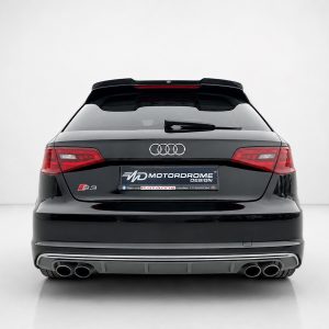 A-487_3jpg - OPSHOLDERS Rear view of a black Audi S3 hatchback showing the Audi rings and dual-tone rear bumper with exhausts and a Motordrome Design plate plate area.