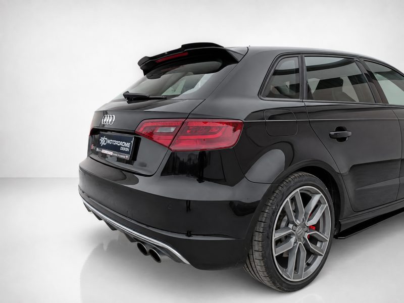 A-487_5jpg - OPSHOLDERS Black Audi sedan shown from a rear three-quarter angle in a bright studio setting, highlighting its taillights and glossy finish.