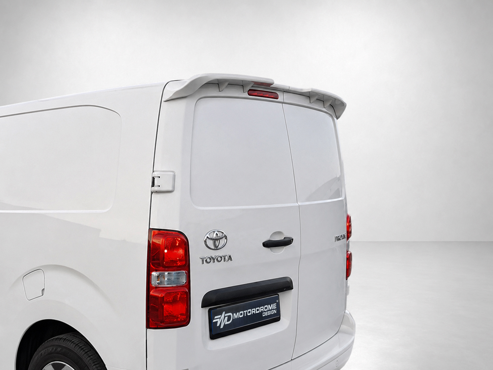 A-488_1jpg - OPSHOLDERS Rear view of a white Toyota van with twin back doors, taillights, and a roof spoiler in a studio setting,