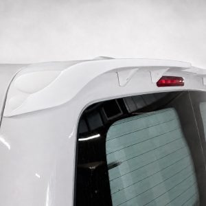 A-488_4jpg - OPSHOLDERS Rear view of a white SUV showing a curved roof spoiler, red brake light, and rear window with defroster lines