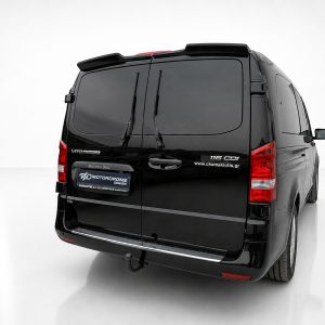 Rear three-quarter view of a black Mercedes-Benz cargo van with tinted rear doors and visible branding on the back doors