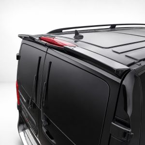 Close-up of the back corner of a black SUV, showing roof rails, rear brake light, and wiper blades.