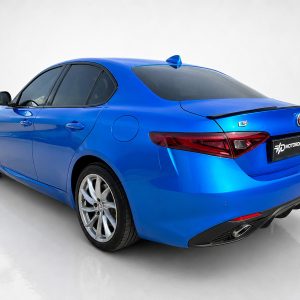 Blue Alfa Romeo sedan shown from rear three-quarter view in a studio setting with a glossy finish.