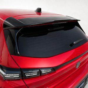Rear view of a red hatchback/SUV showing a dark rear window, wiper, and a black roof spoiler glaze above the tailgate.