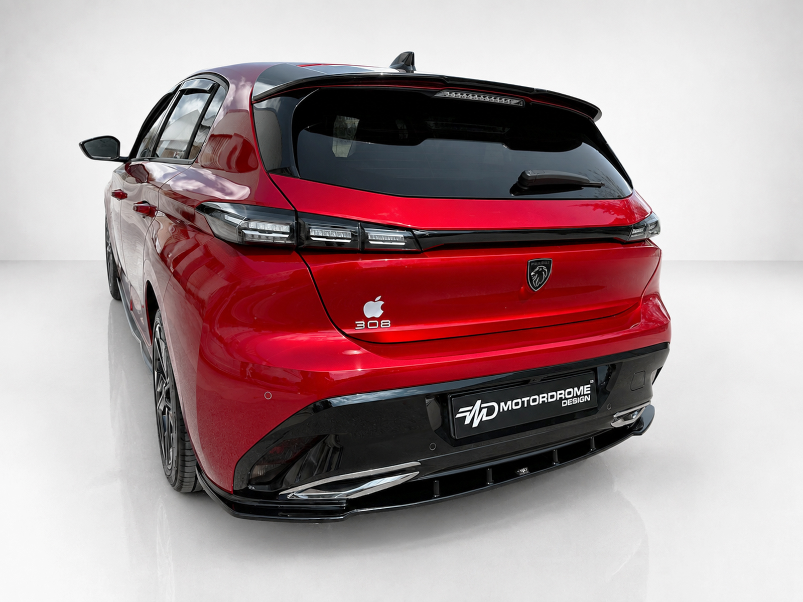 A-492_2jpg - OPSHOLDERS Rear three-quarter view of a red Peugeot 308 hatchback with a black roof spoiler and an Apple logo sticker on the trunk.
