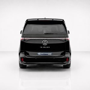 Rear view of a black VW ID. BUZZ van in a studio, brand emblem visible at center.