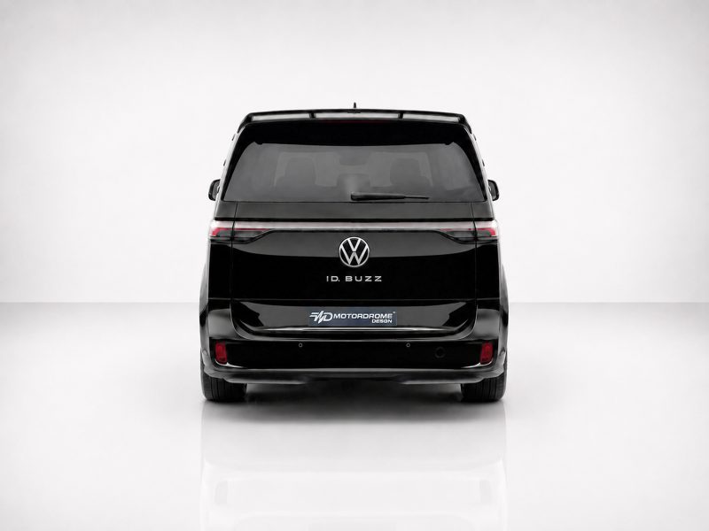Rear view of a black VW ID. BUZZ van in a studio, brand emblem visible at center.