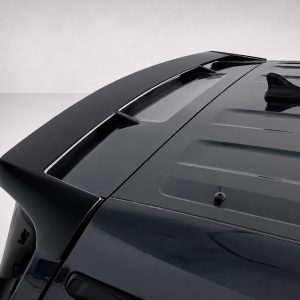 Close-up of the dark car roof showing a rear spoiler and antenna on a glossy surface.