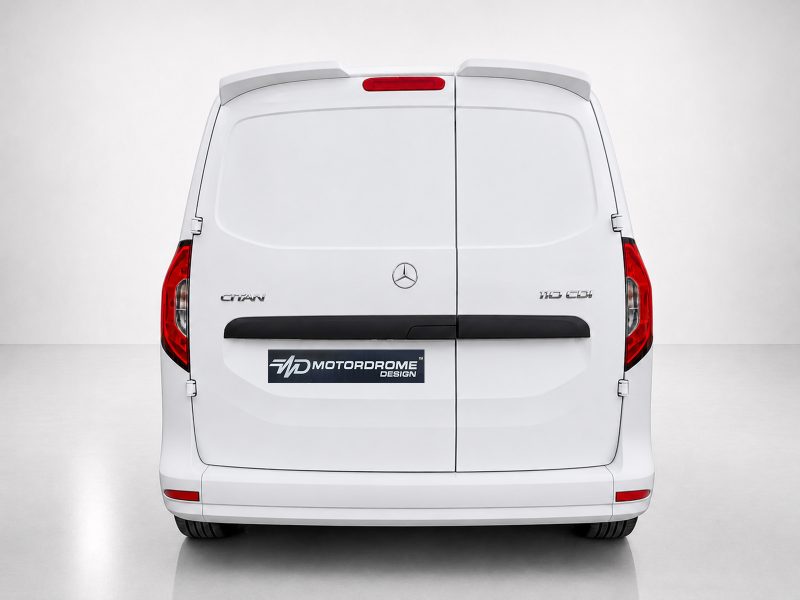 Rear view of a white Mercedes van with split rear doors, red taillights, and a MD Motordome Design plate badge above the bumper.