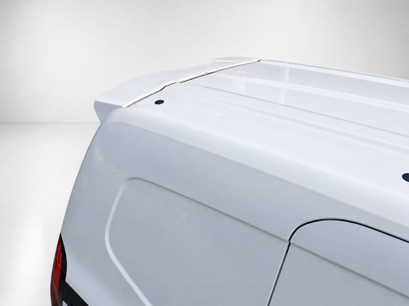 Close-up of the back of a white pickup truck, showing the tonneau cover over the bed and part of the tail light