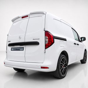 White Mercedes-style cargo van shown from a rear three-quarter angle in a studio, highlighting its rear doors and aftermarket alloy wheels.