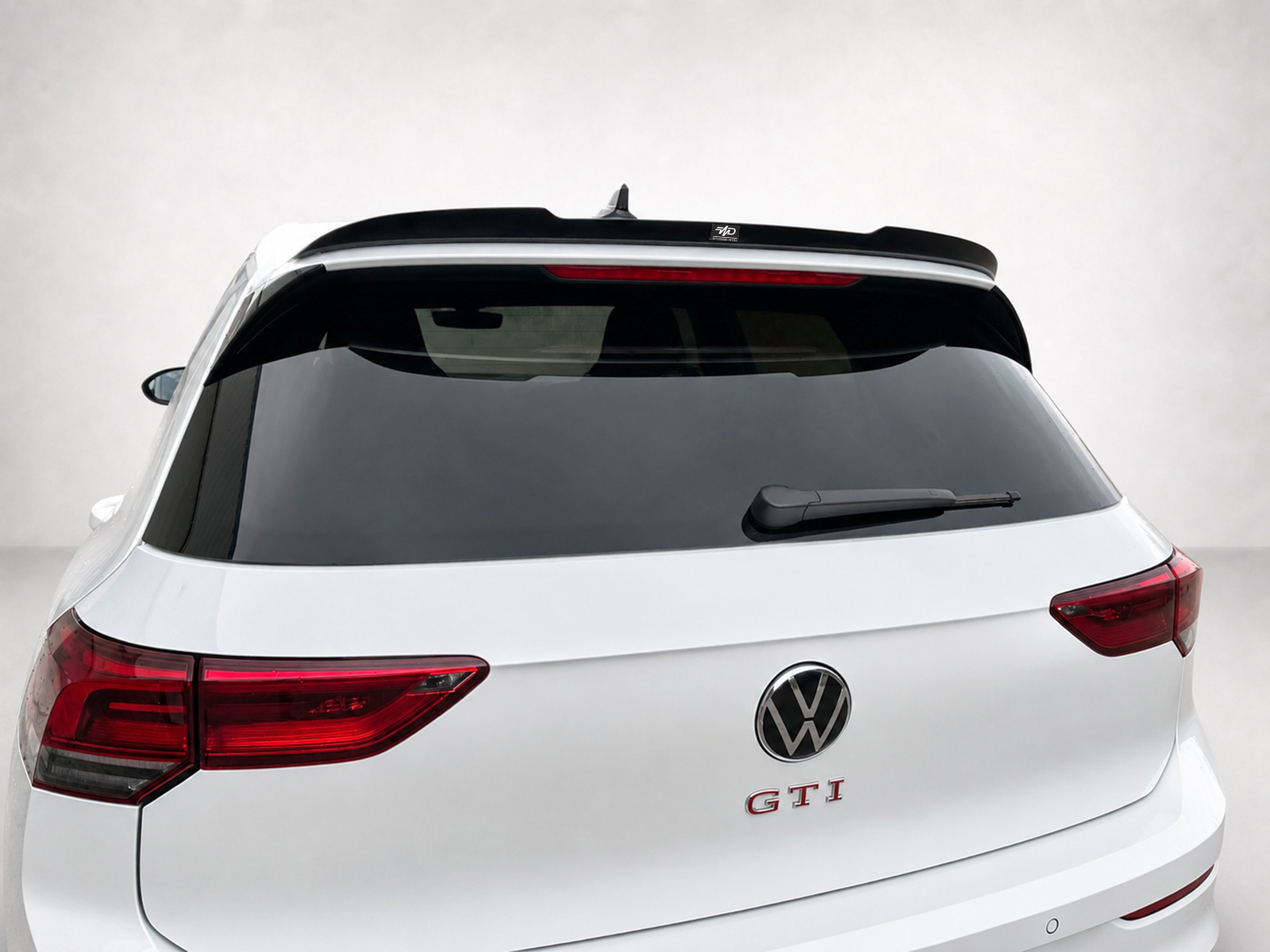 A-496_1jpg - OPSHOLDERS Rear view of a white Volkswagen SUV showing the GTI badge and VW emblem, with red taillights and rear wiper visible on the back window.