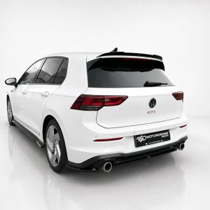 A-496_2jpg - OPSHOLDERS White VW Golf GTI wagon photographed from the rear-left side in a studio setting, showing taillights and dual exhausts