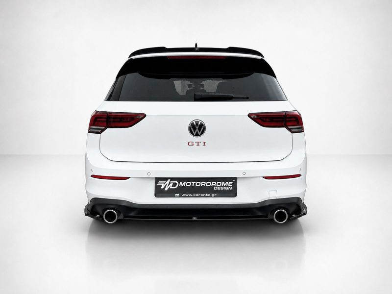 A-496_3jpg - OPSHOLDERS Rear view of a white Volkswagen GTI hatchback in a studio, showing red tail lights and dual exhausts.