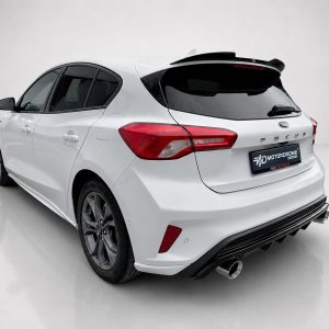 A-497_2jpg - OPSHOLDERS Rear three-quarter view of a white Ford hatchback with red taillights, black rear window, and dual exhausts in a studio setting