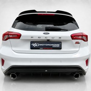 A-497_3jpg - OPSHOLDERS Rear view of a white Ford Focus ST-Line hatchback with red taillights and a Motordrome Design plate on the bumper.