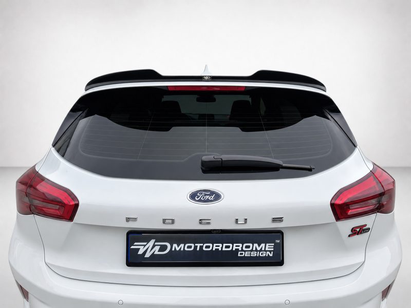 A-497_6jpg - OPSHOLDERS Rear view of a white Ford Focus hatchback with a black roof spoiler and MOTORDROME DESIGN plate on the bumper.