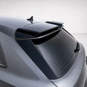 Rear view of a gray hatchback car showing a roof spoiler and rear window with defroster lines.