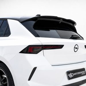 White crossover SUV rear with black roof spoiler and Opel emblem on the tailgate.