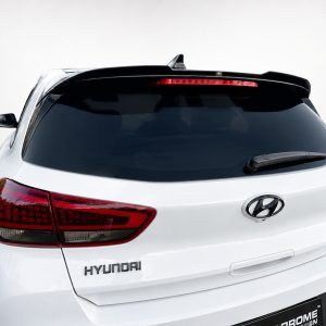 Rear view of a white Hyundai SUV, showing the tail lights, rear window, and logo