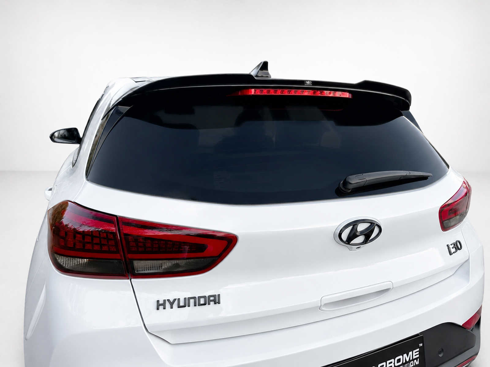 A-502_1jpg - OPSHOLDERS Rear view of a white Hyundai SUV, showing the tail lights, rear window, and logo