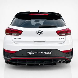A-502_3jpg - OPSHOLDERS Rear view of a white Hyundai i30 hatchback, showing red taillights, black rear diffuser, and a Motordrome Design plate on the bumper.