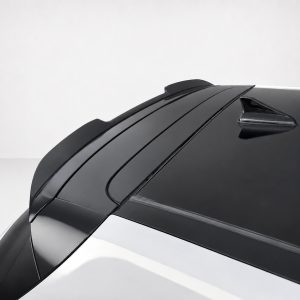 A-502_4jpg - OPSHOLDERS Close-up of a car roof with a glossy black rear window and a shark-fin antenna. (Informative image)