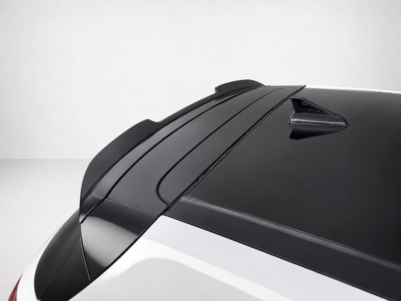 A-502_4jpg - OPSHOLDERS Close-up of a car roof with a glossy black rear window and a shark-fin antenna. (Informative image)