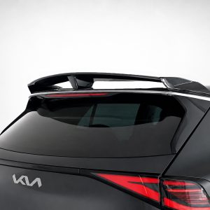 Rear view of a black Kia SUV featuring a prominent spoiler and red taillights against a light background