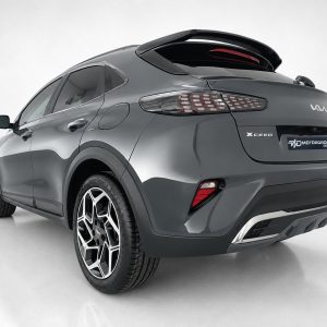 Rear three-quarter view of a gray Kia XCeed crossover, highlighting alloy wheels and distinctive taillights.