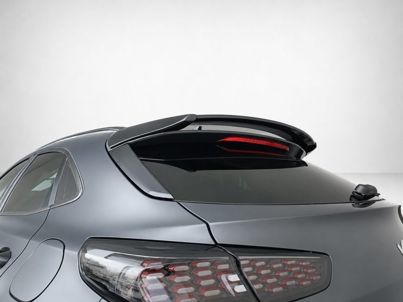 Rear view of a metallic gray car featuring a raised rear spoiler and stylish LED taillights.