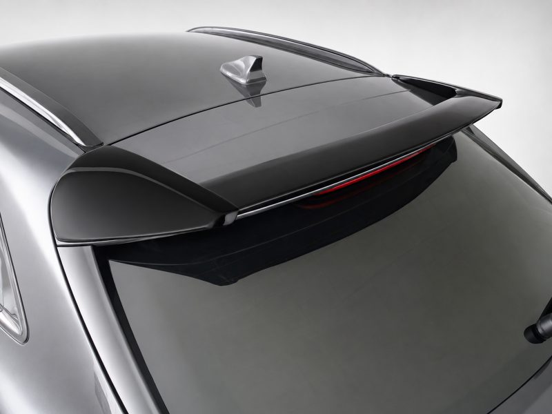 Close-up of a silver car roof with a rear spoiler and small antenna on top.