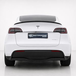 Rear view of a white Tesla Model Y with a dark rear window and red-taillights, displaying a Motordrome Design plate badge on the trunk.
